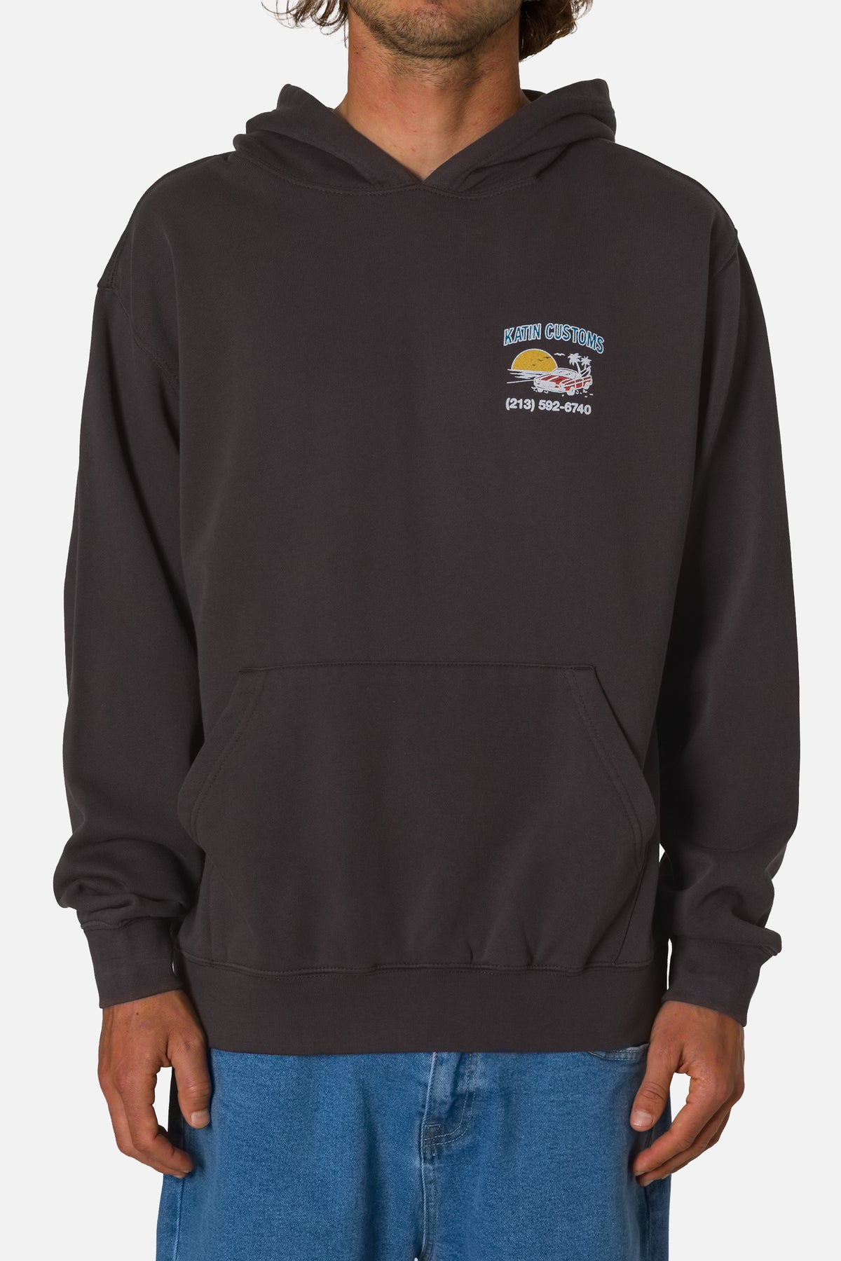 Person wearing a black hoodie with a logo on a white background