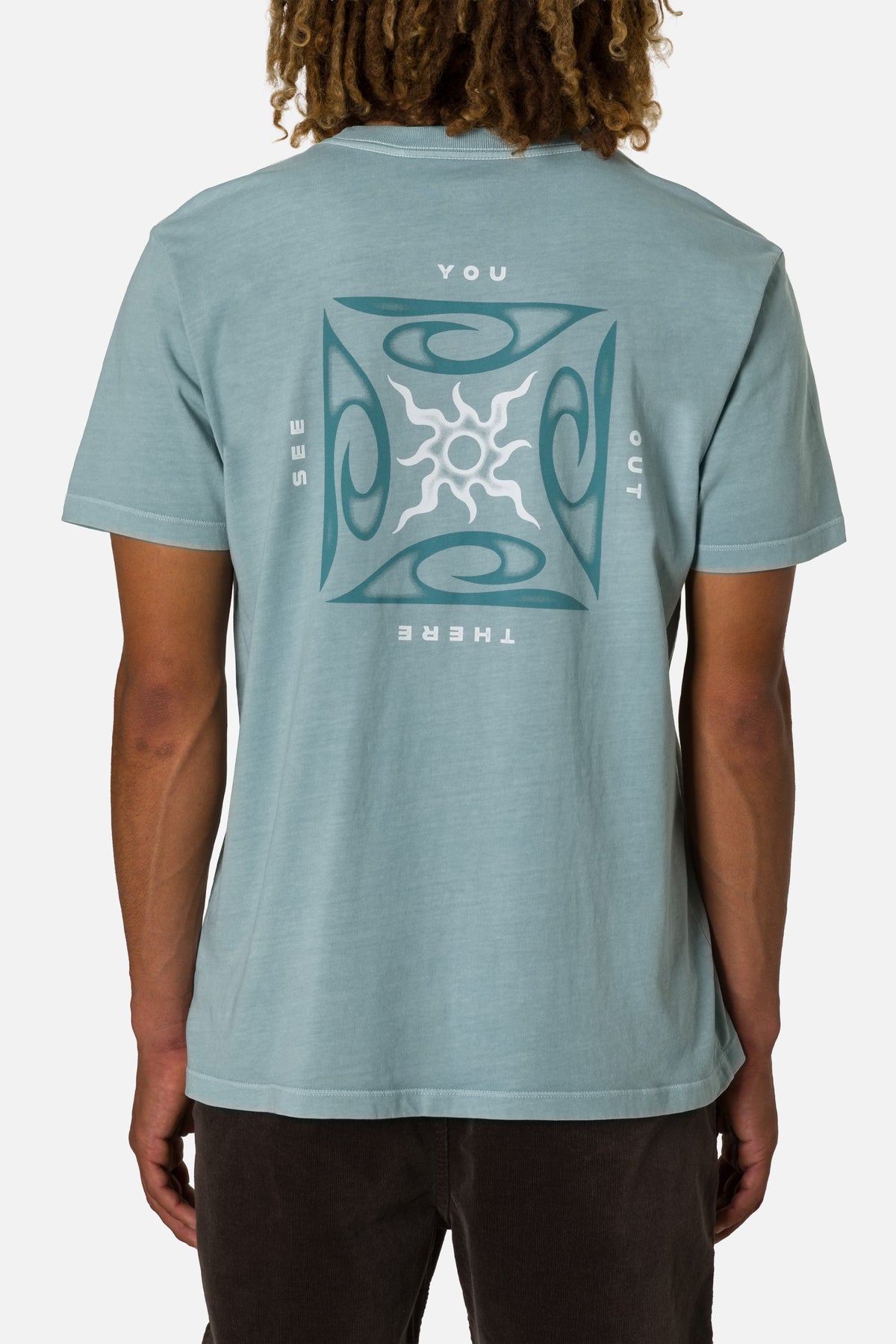 Person wearing a light blue t-shirt with a sun design on the back against a white background