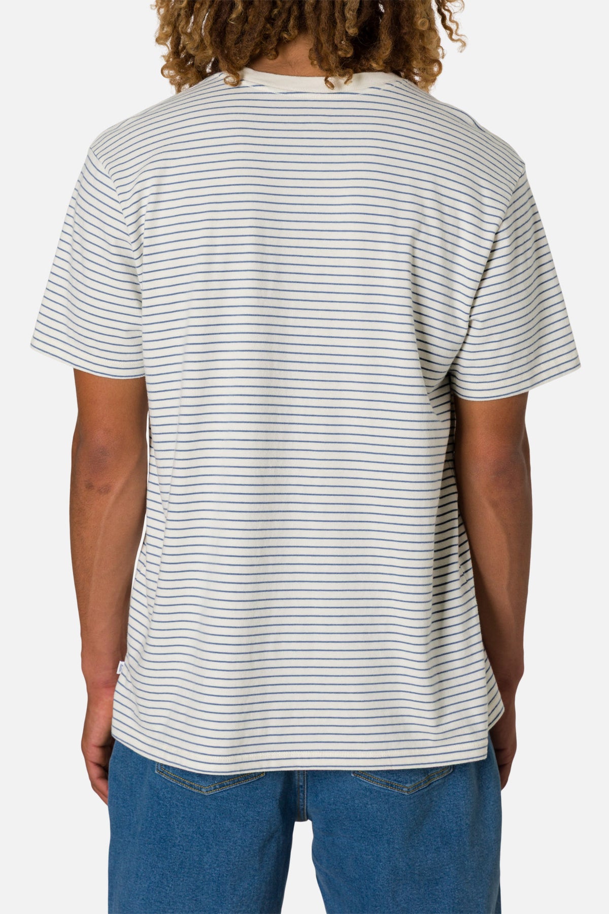 Person wearing a striped t-shirt and blue jeans on a white background
