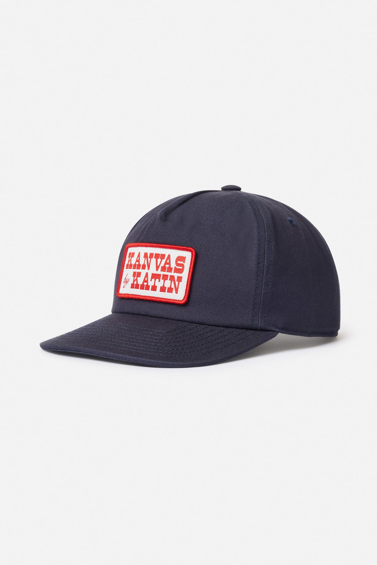 Navy blue cap with a red and white logo patch on a light gray background
