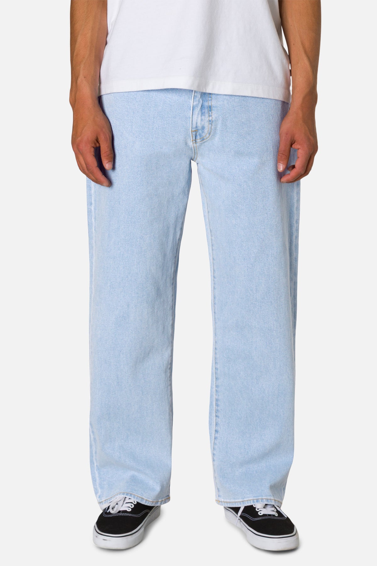 Light blue jeans worn by a person on a white background