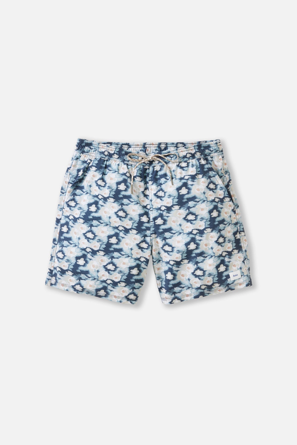 Blue and white floral patterned shorts on a light gray background