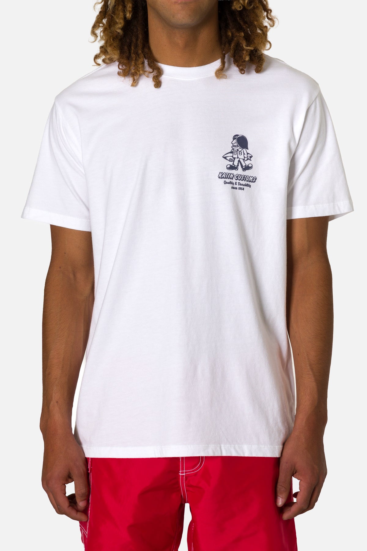 Person wearing a white t-shirt with a graphic design on a plain background