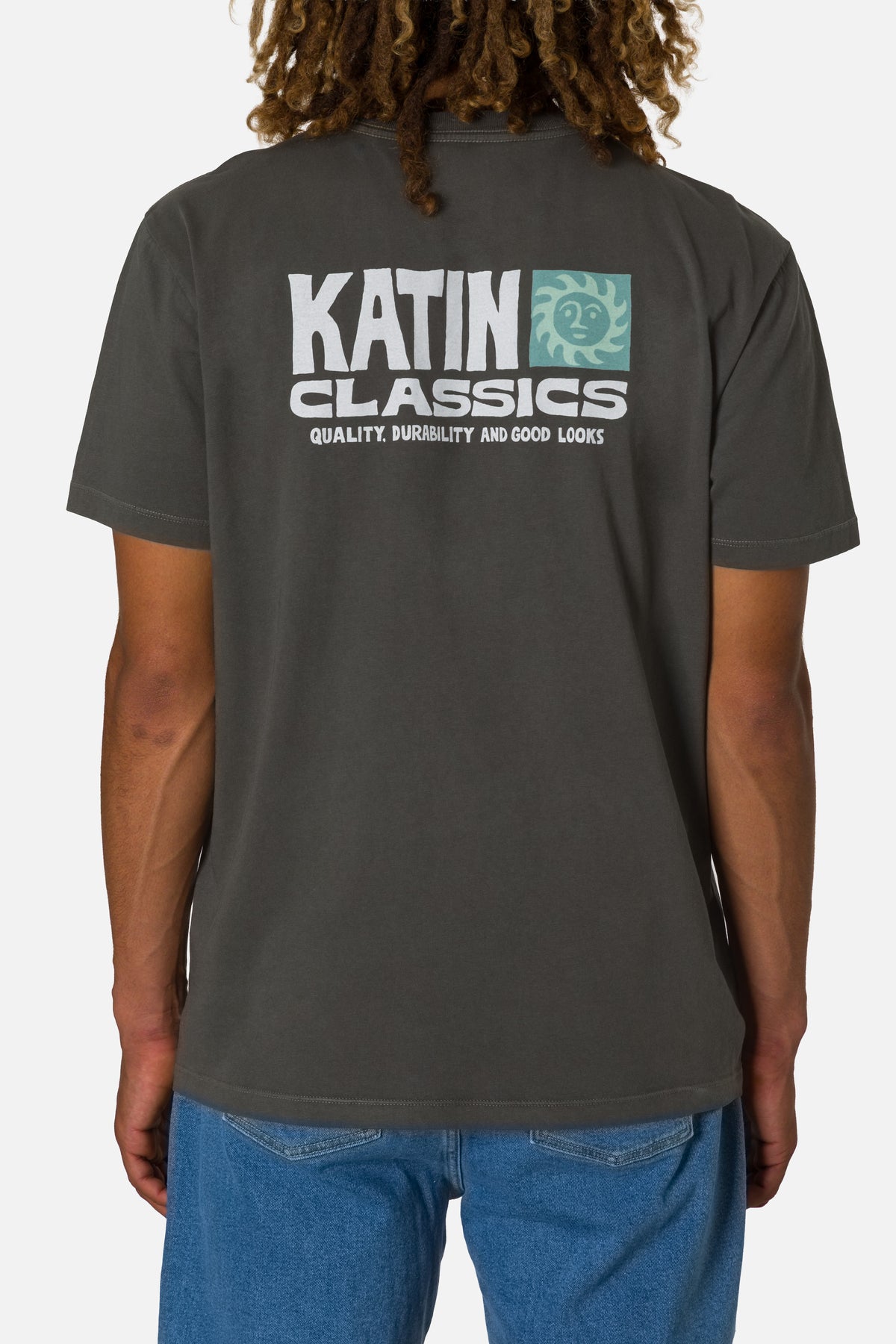 Person wearing a dark gray t-shirt with 'Katin Classics' logo on the back, standing against a white background.