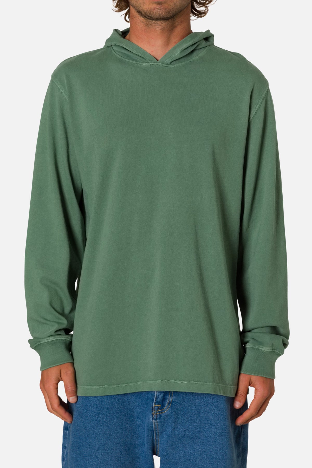 Person wearing a green hoodie and blue jeans on a white background