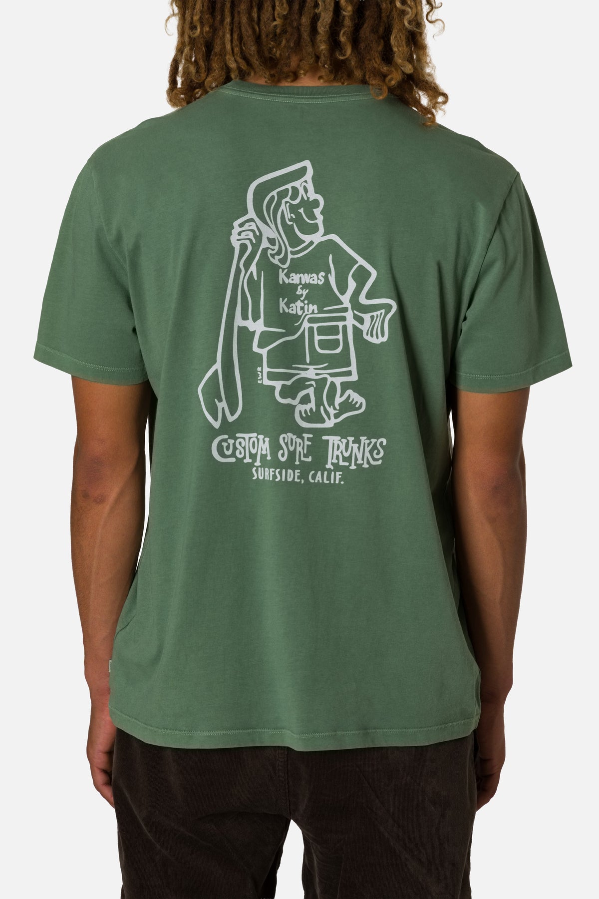 Person wearing a green t-shirt with a white graphic design on the back