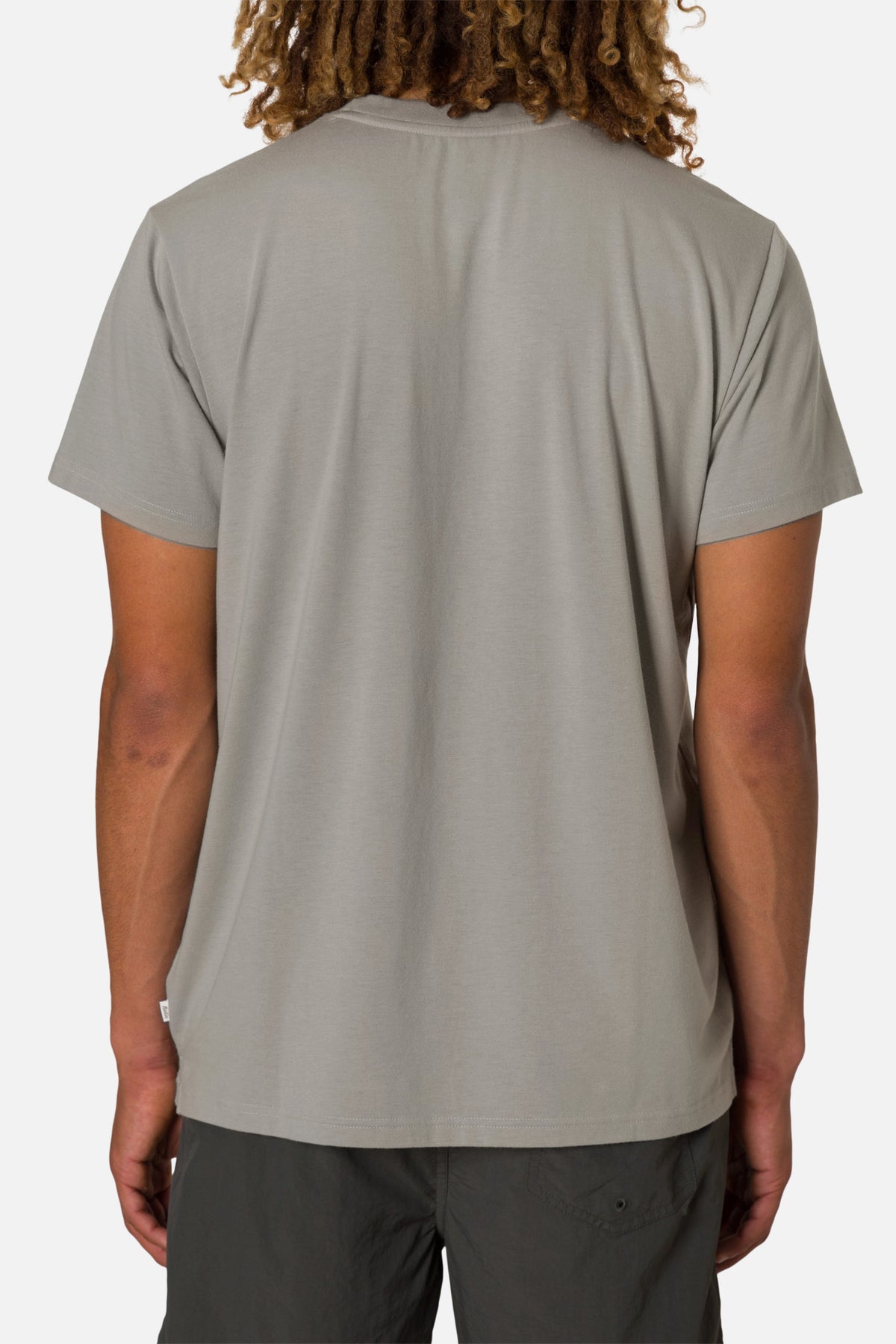 Person wearing a gray t-shirt on a white background