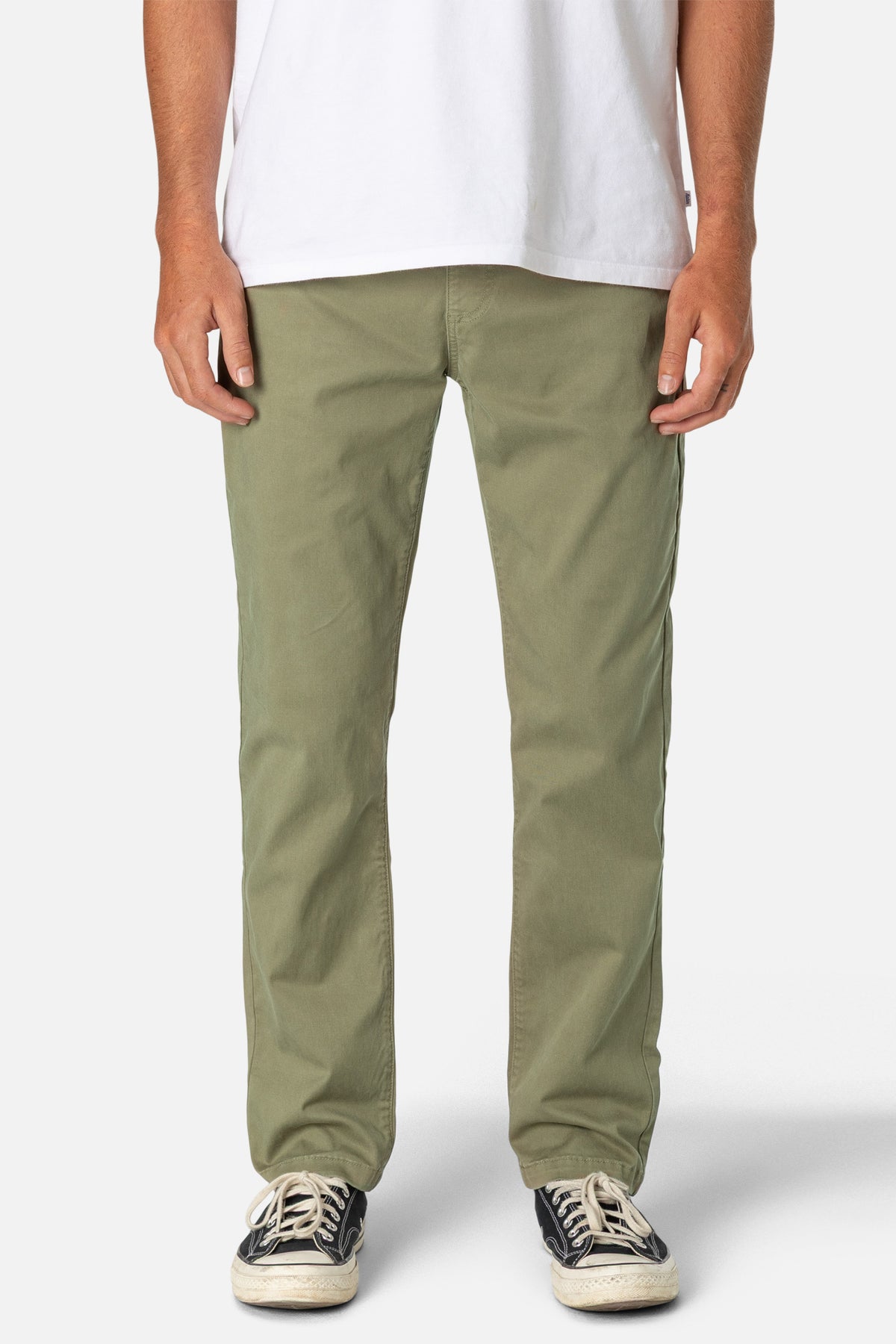 Person wearing olive green pants and a white shirt on a white background