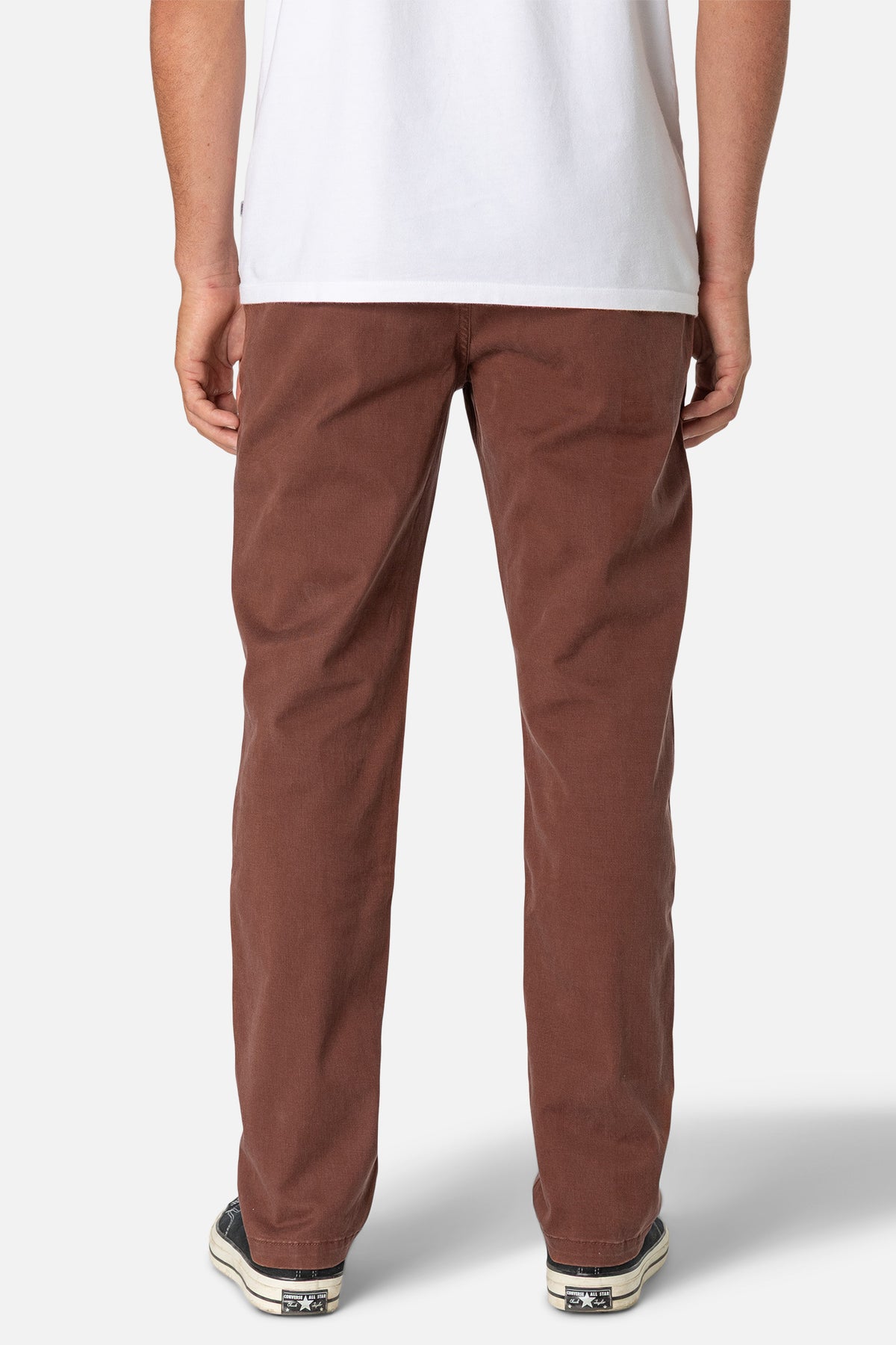 Brown pants worn by a person on a white background