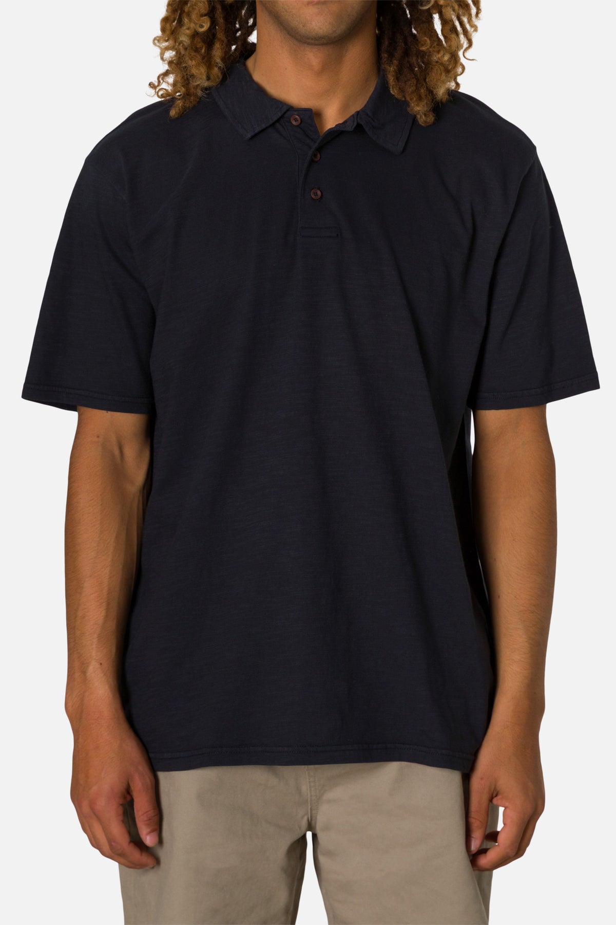Person wearing a black polo shirt on a white background