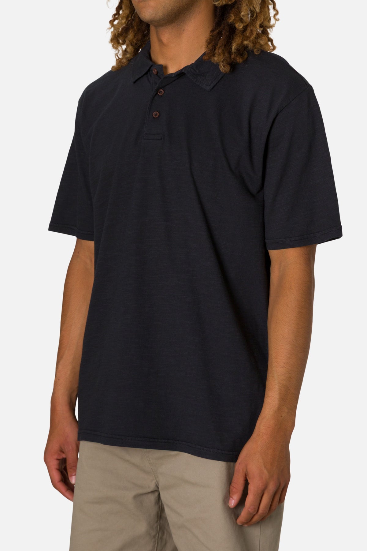 Person wearing a black polo shirt on a white background