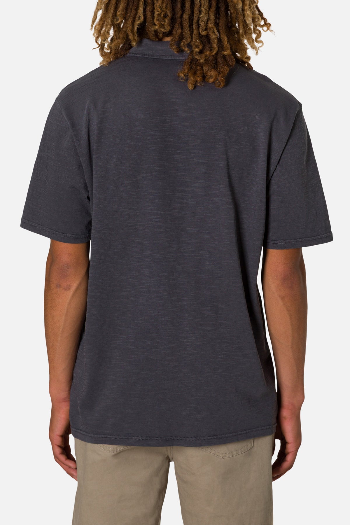 Person wearing a dark gray polo shirt on a plain background