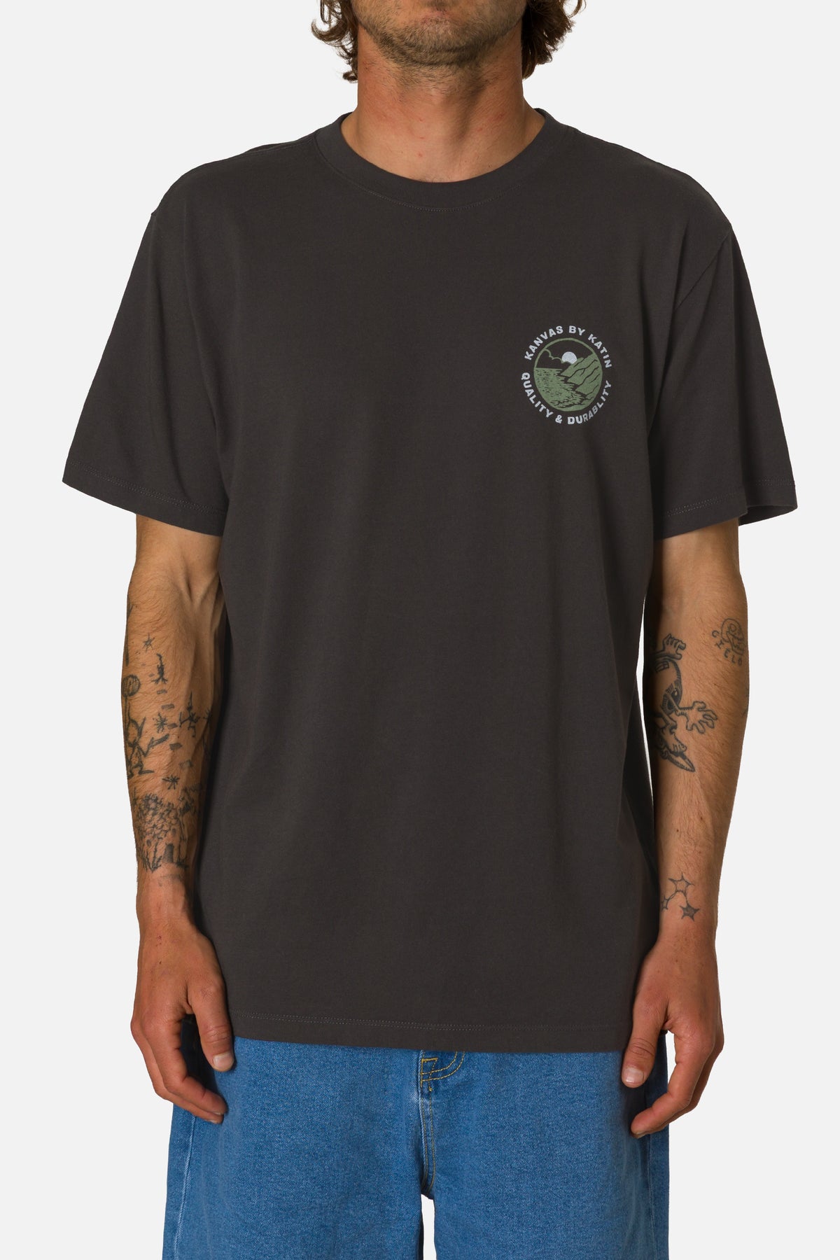 Person wearing a black t-shirt with a logo on a white background