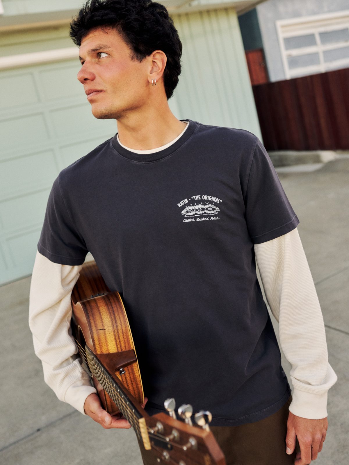 Katin Shuck Tee in Polar Navy organic cotton, on model with a guitar, front “The Original” oyster graphic, lifestyle #color_polar navy vintage wash