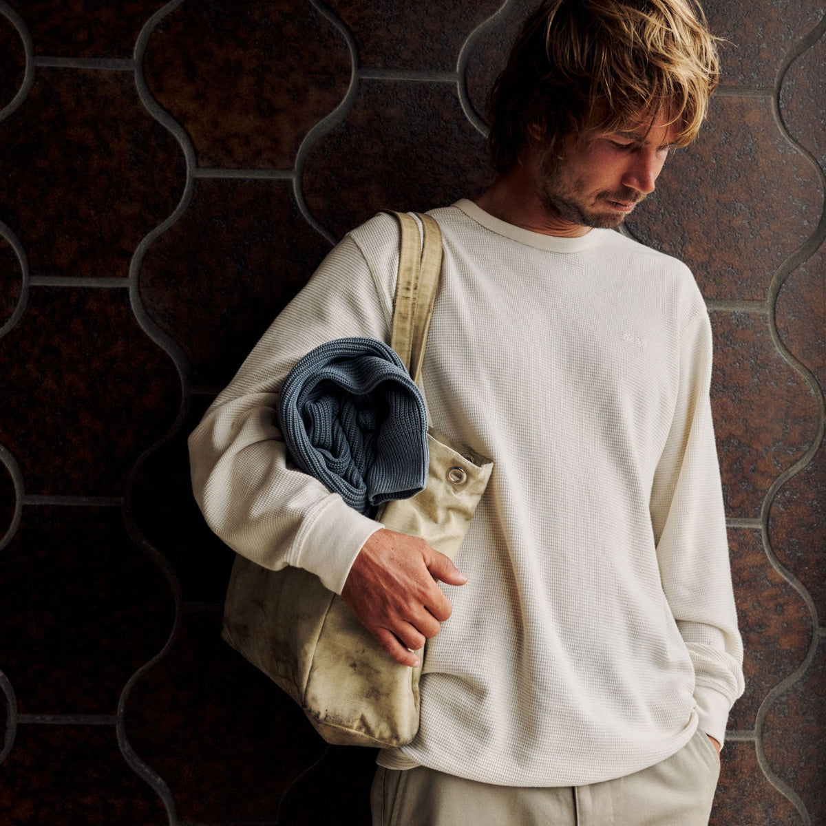 A man wearing a off white Katin sweater