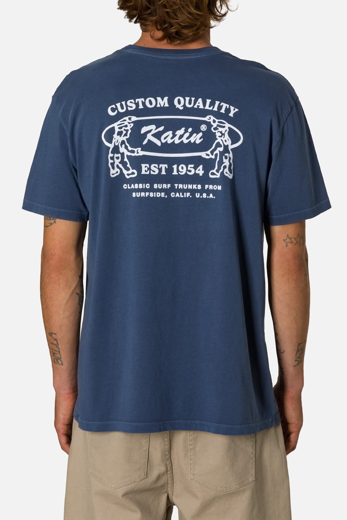 Person wearing a blue t-shirt with 'Katin' branding on the back