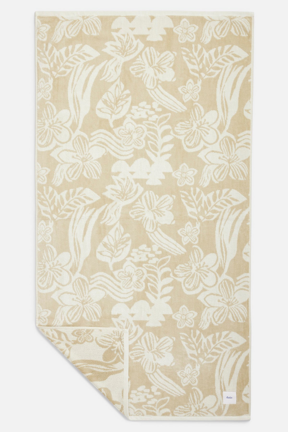 Beige towel with white floral pattern on a white background