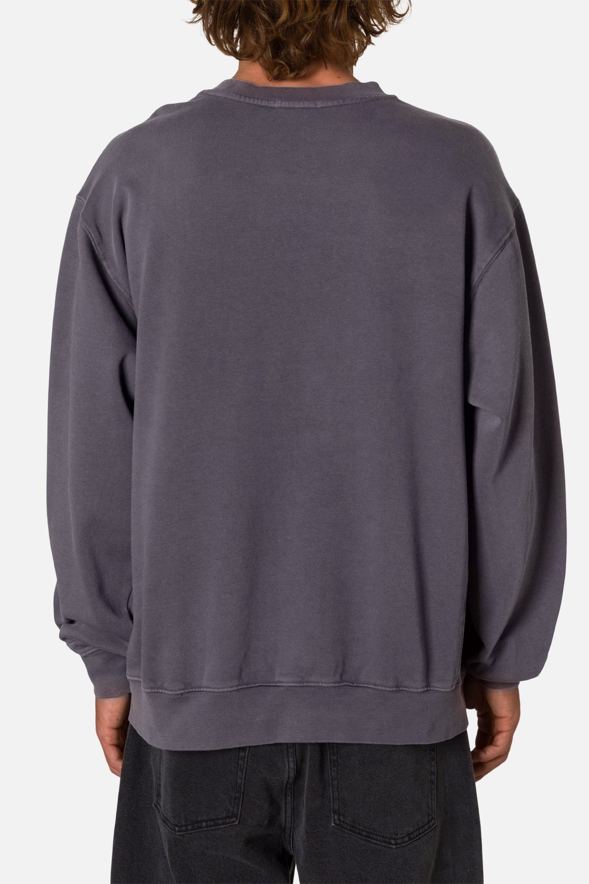 Back of a person wearing a deep blue sweatshirt  on a white background