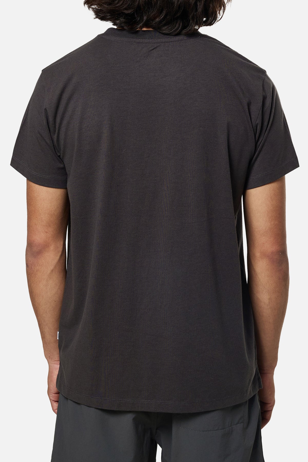 Person wearing a black t-shirt on a white background