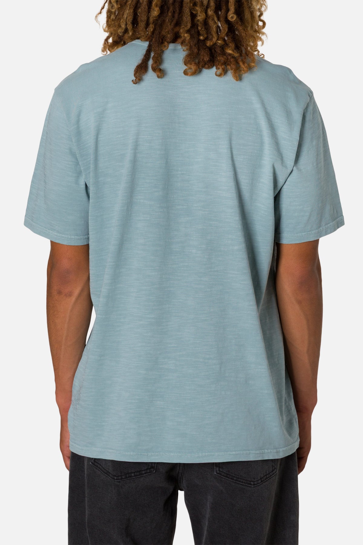 Person wearing a light blue t-shirt on a white background