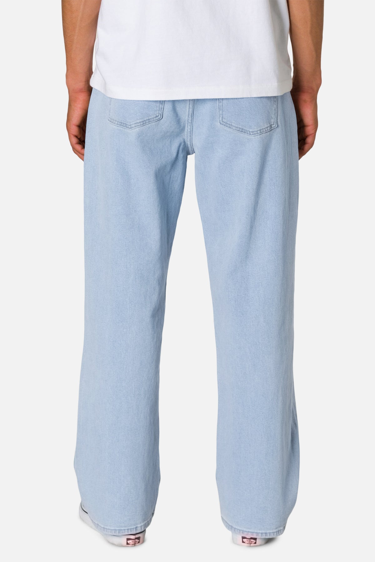 Light blue jeans worn by a person on a white background