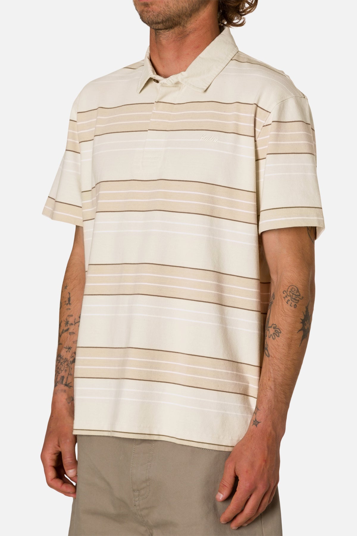 Man wearing a beige and brown striped polo shirt on a white background