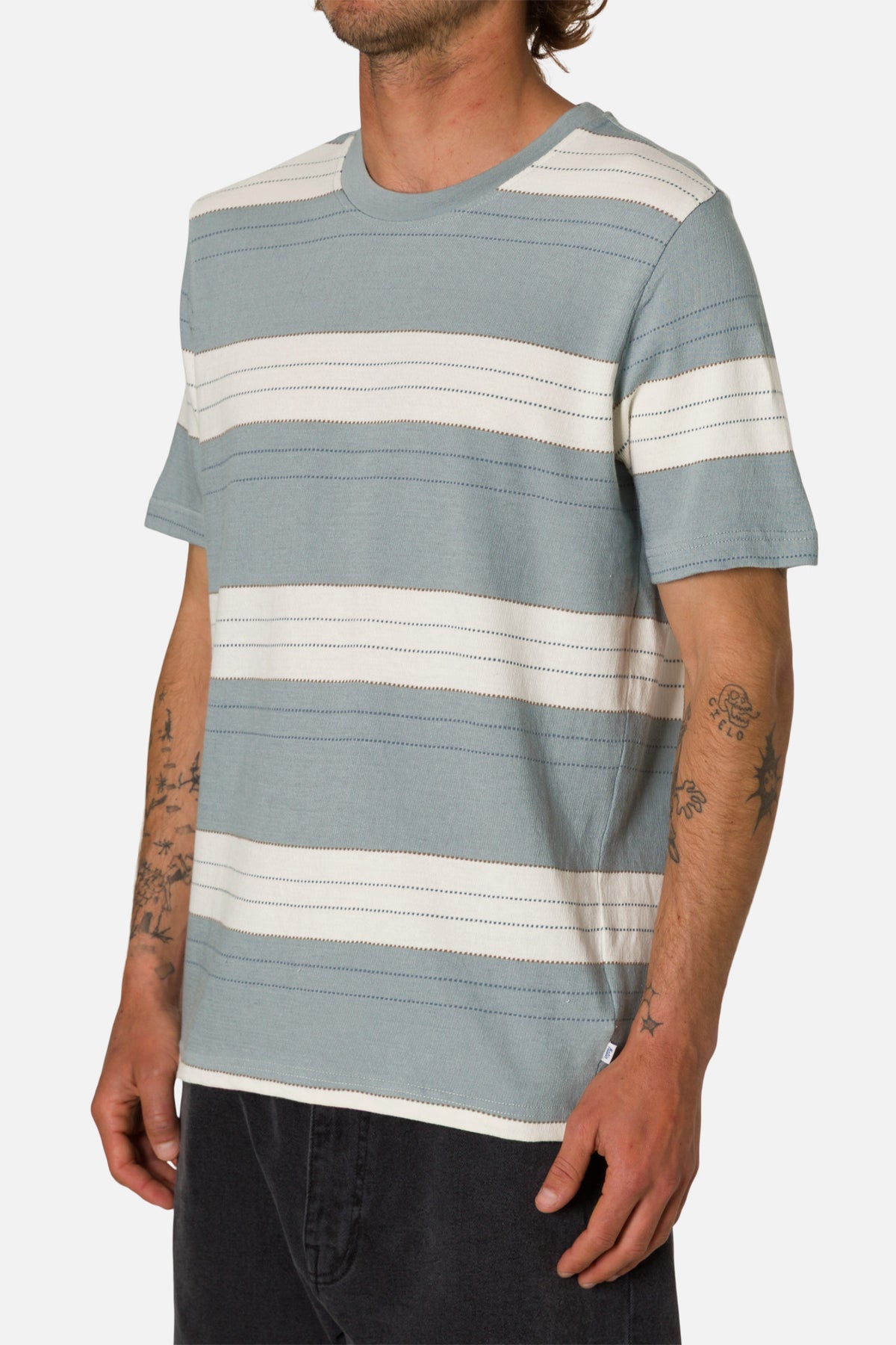 Man wearing a blue and white striped t-shirt on a white background