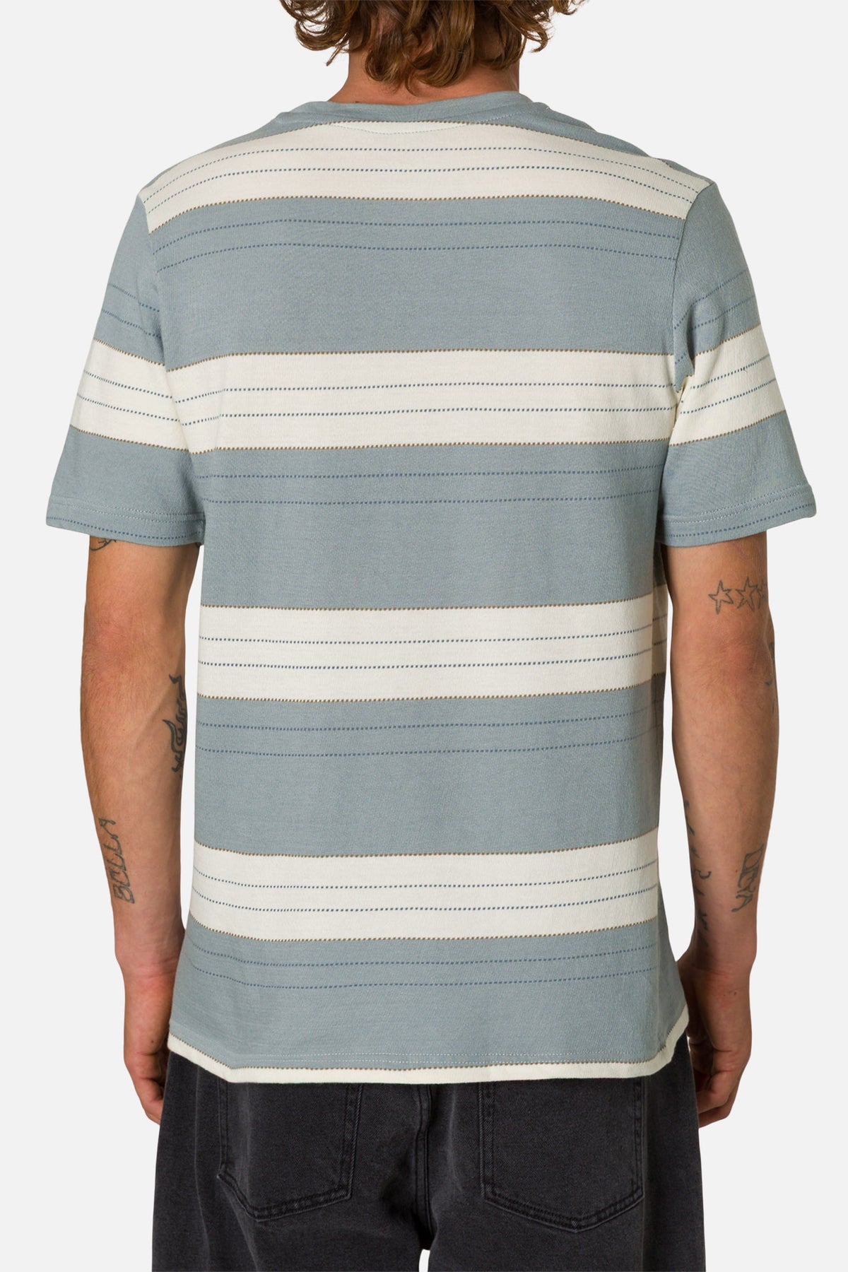 Person wearing a striped t-shirt with a plain background