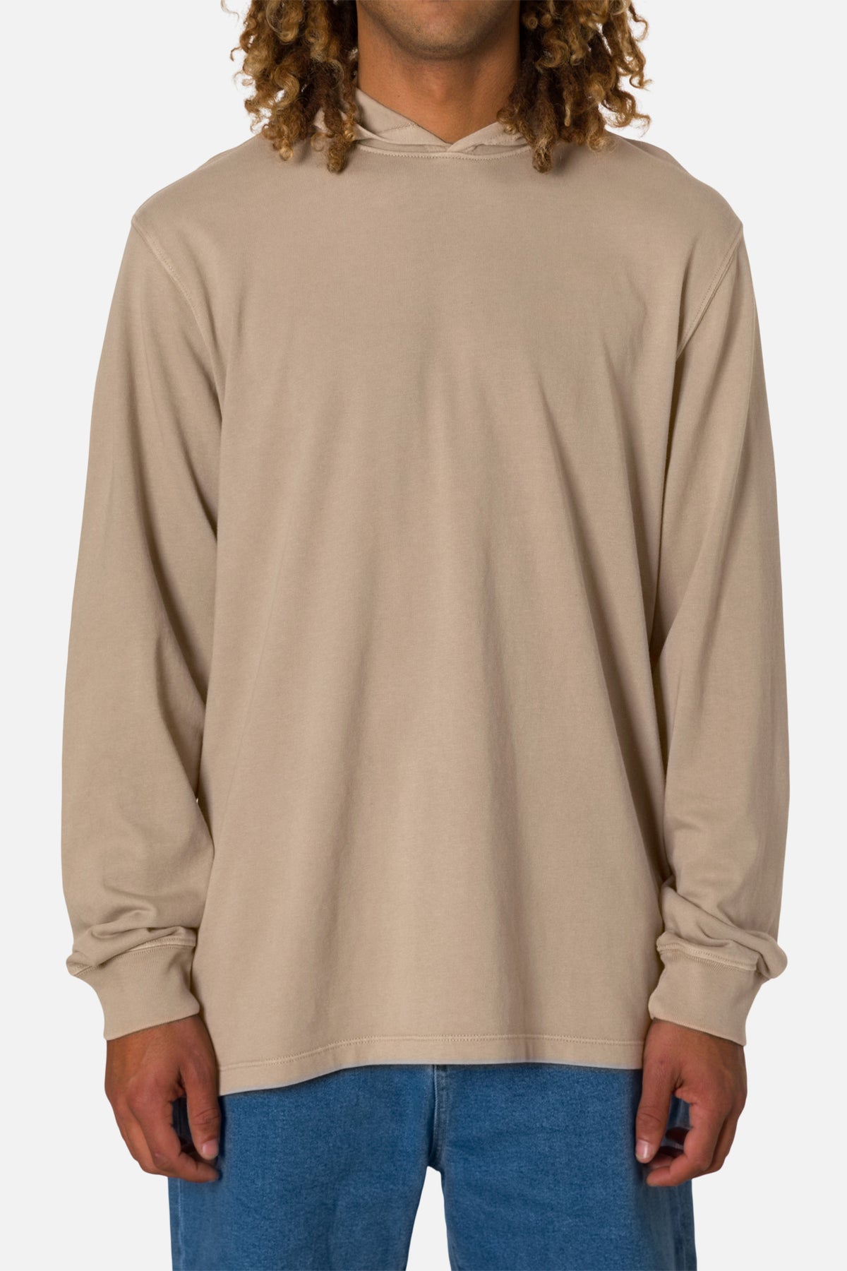 Person wearing a beige long-sleeve hoodie on a white background