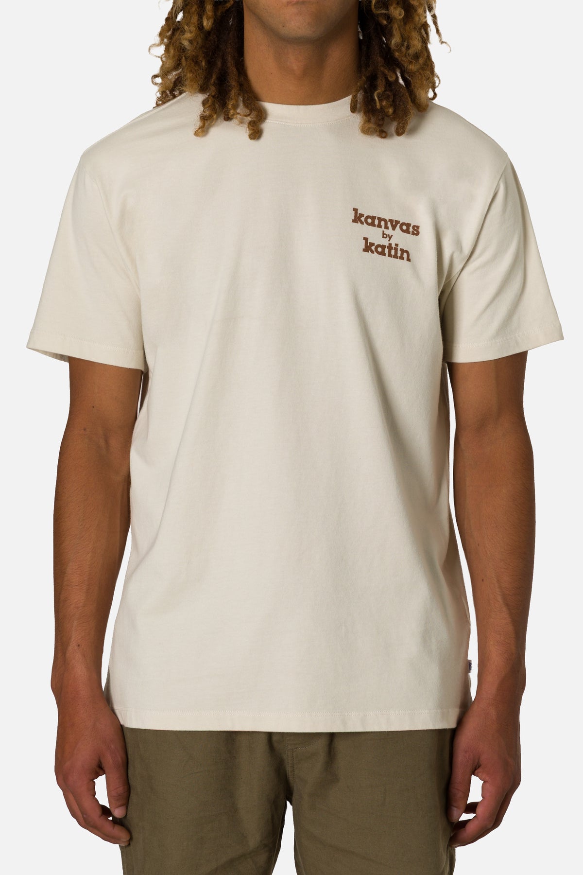 Person wearing a beige t-shirt with 'kanvas by katin' text on a white background