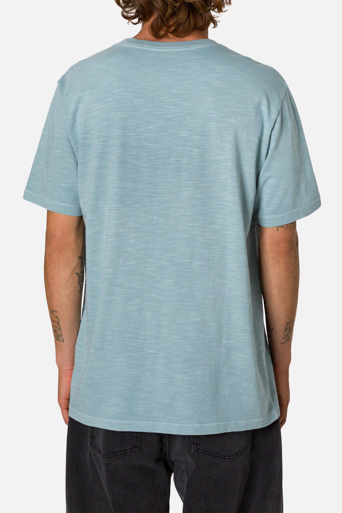 Person wearing a light blue t-shirt on a white background