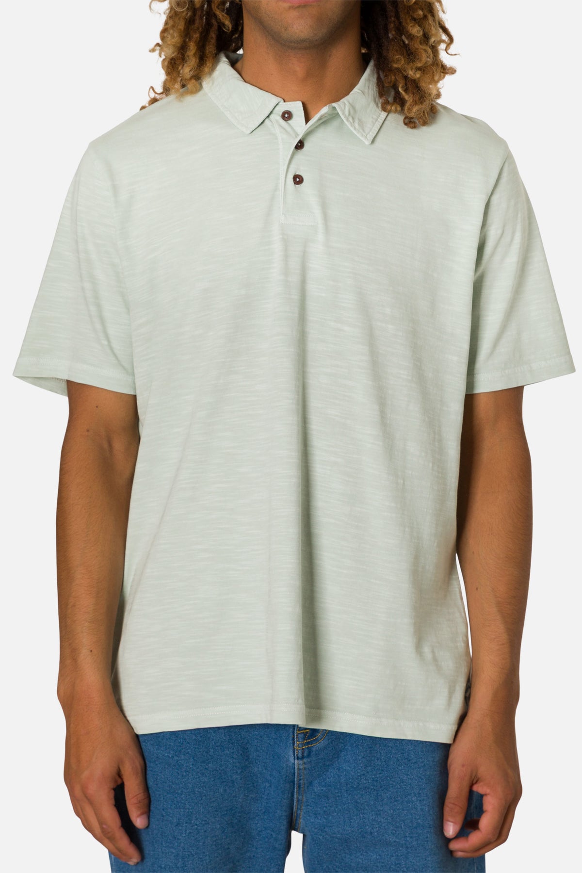 Man wearing a light gray polo shirt with a collar on a white background