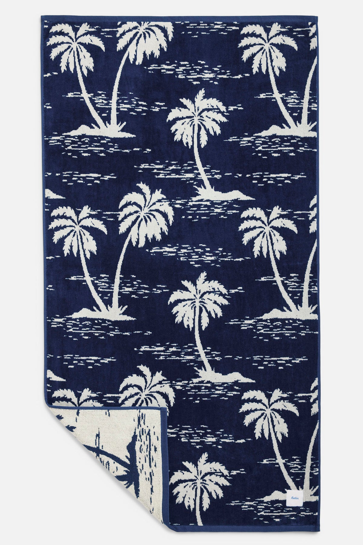Navy blue towel with white palm tree pattern