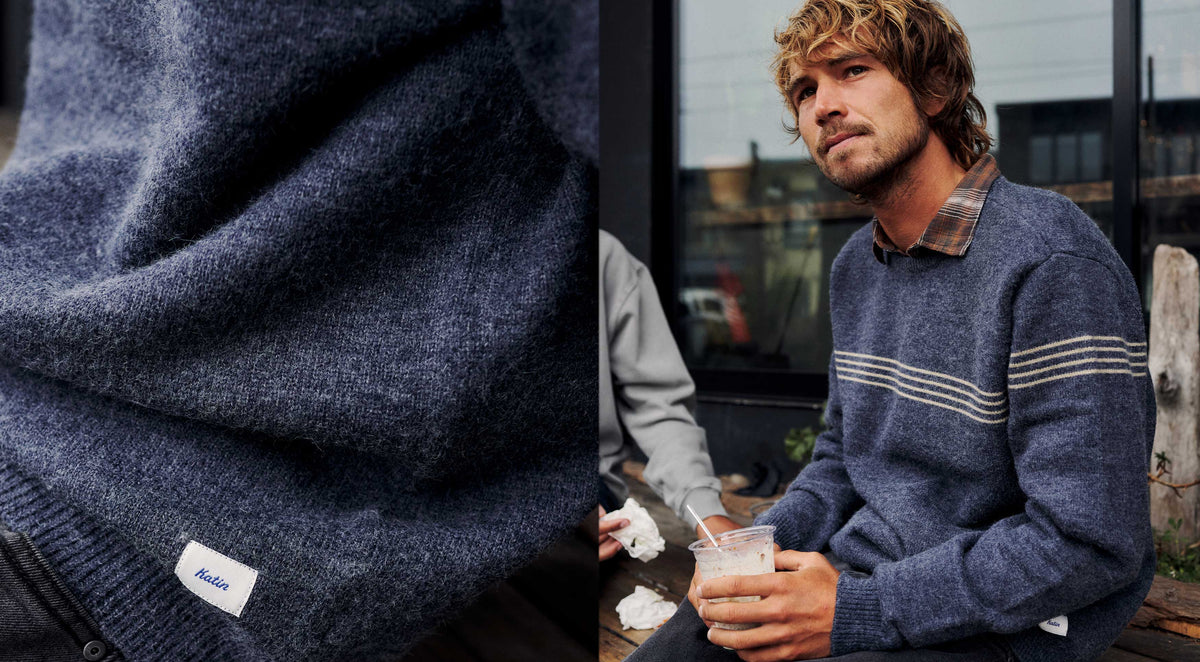 Close-up of the Charles Sweater’s brushed knit and Katin label, beside a man wearing the navy Charles Sweater with cream chest stripes over a plaid shirt
