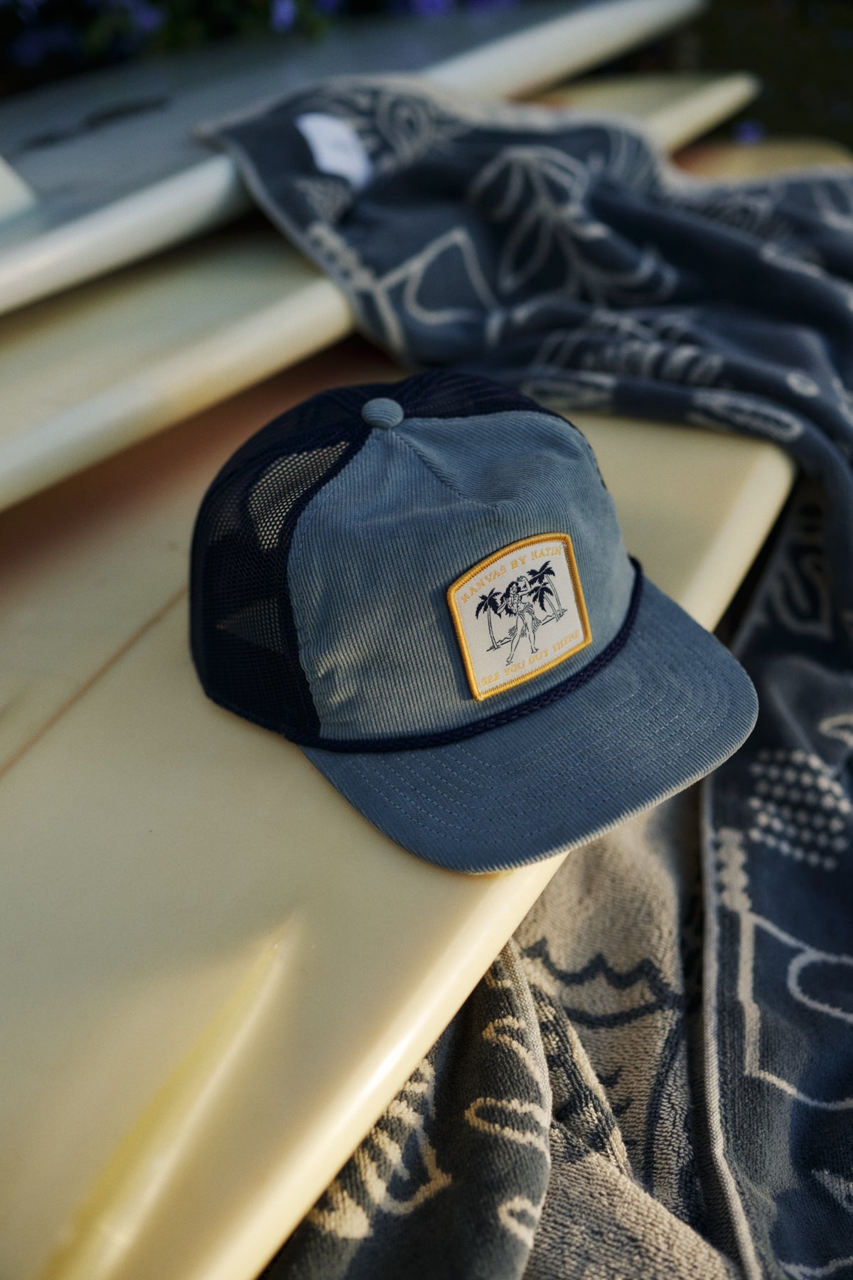 Blue cap with a patch on a surfboard