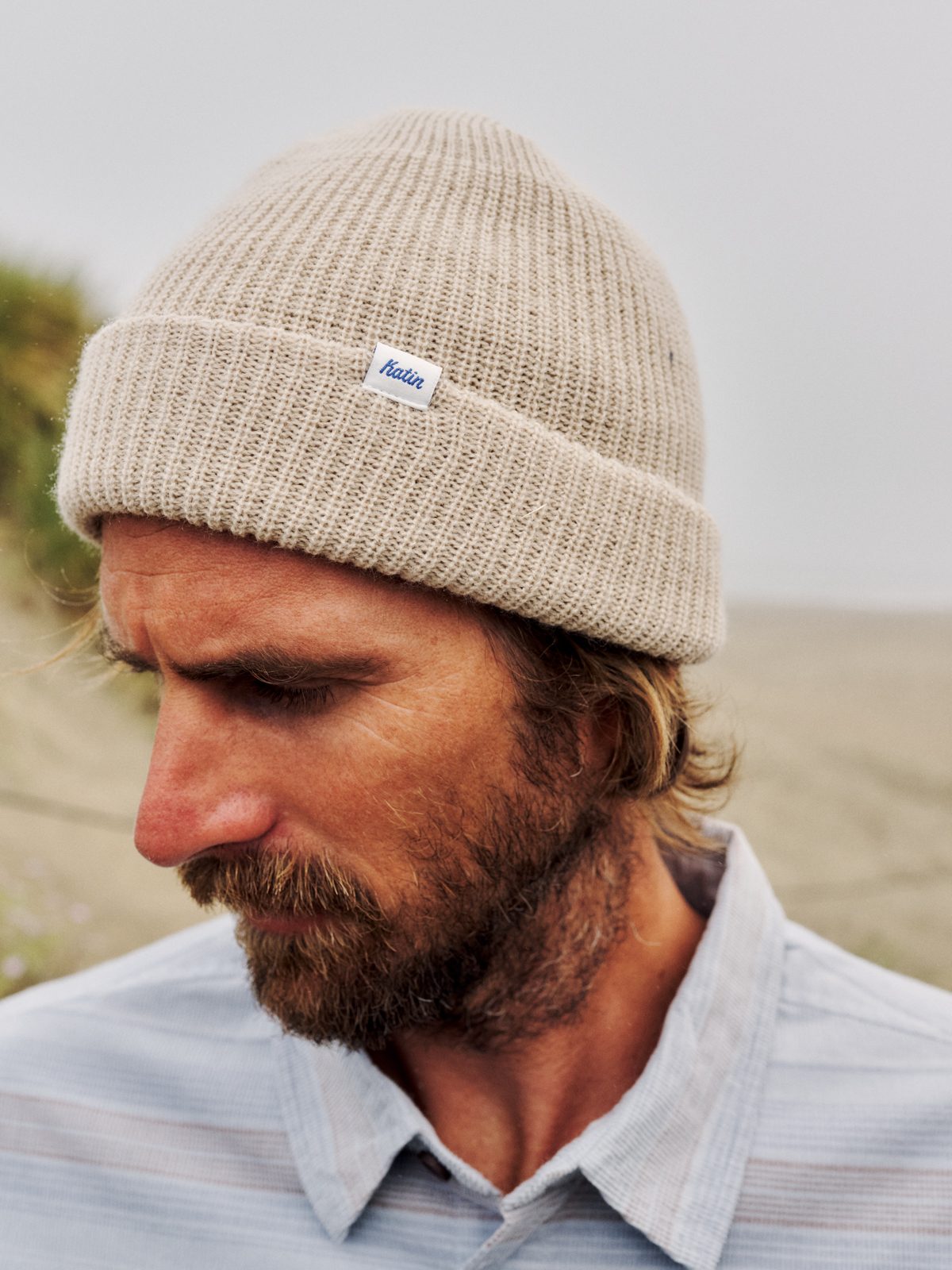 Katin Edwin Beanie in Stone, a watch cap cuff knit with a Katin woven label, on model, lifestyle #color_stone