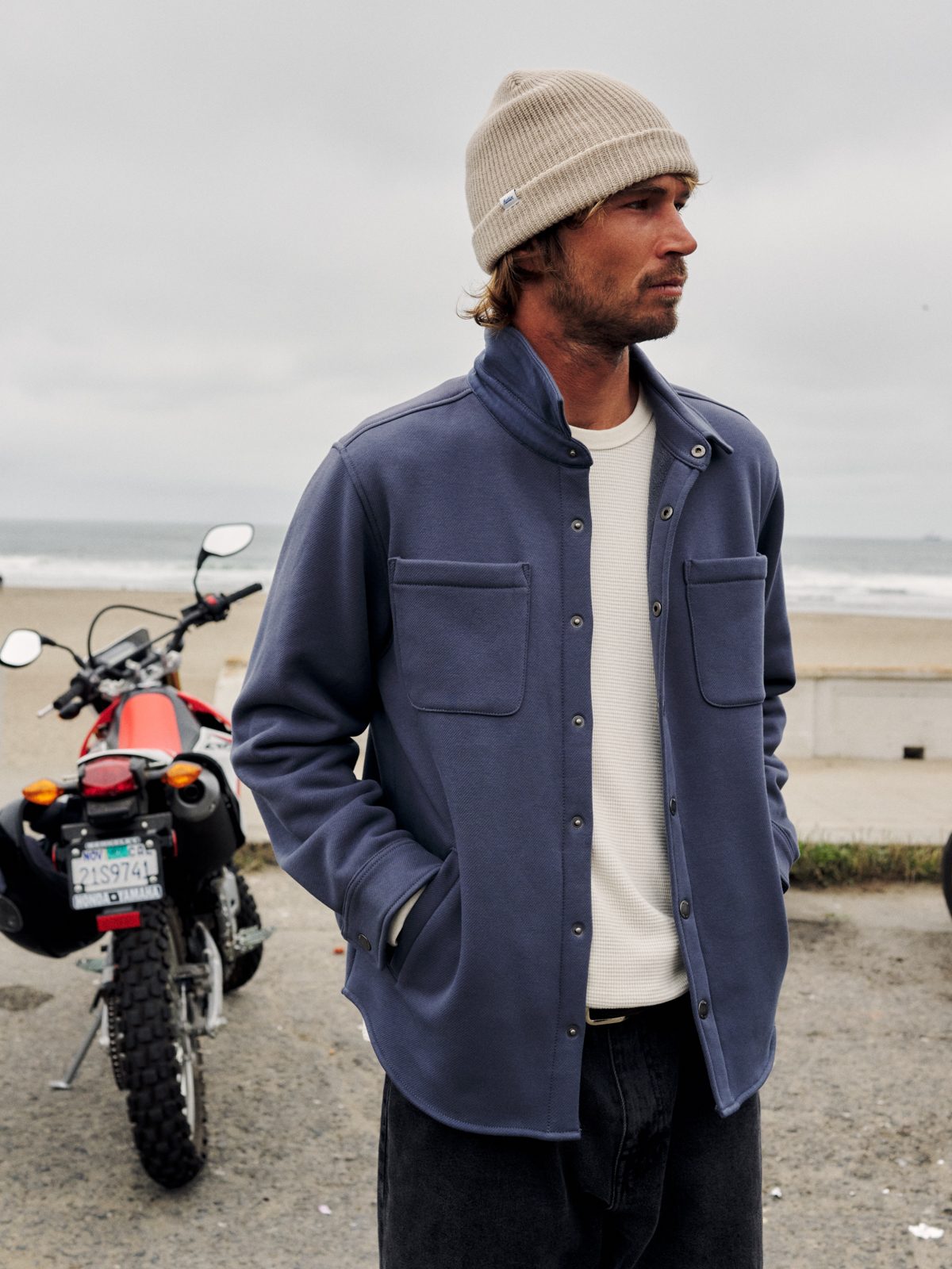 Katin Harold Fleece Shirt Jacket in Washed Blue, fleece-back twill with snap front, on model at the beach, lifestyle #color_washed blue