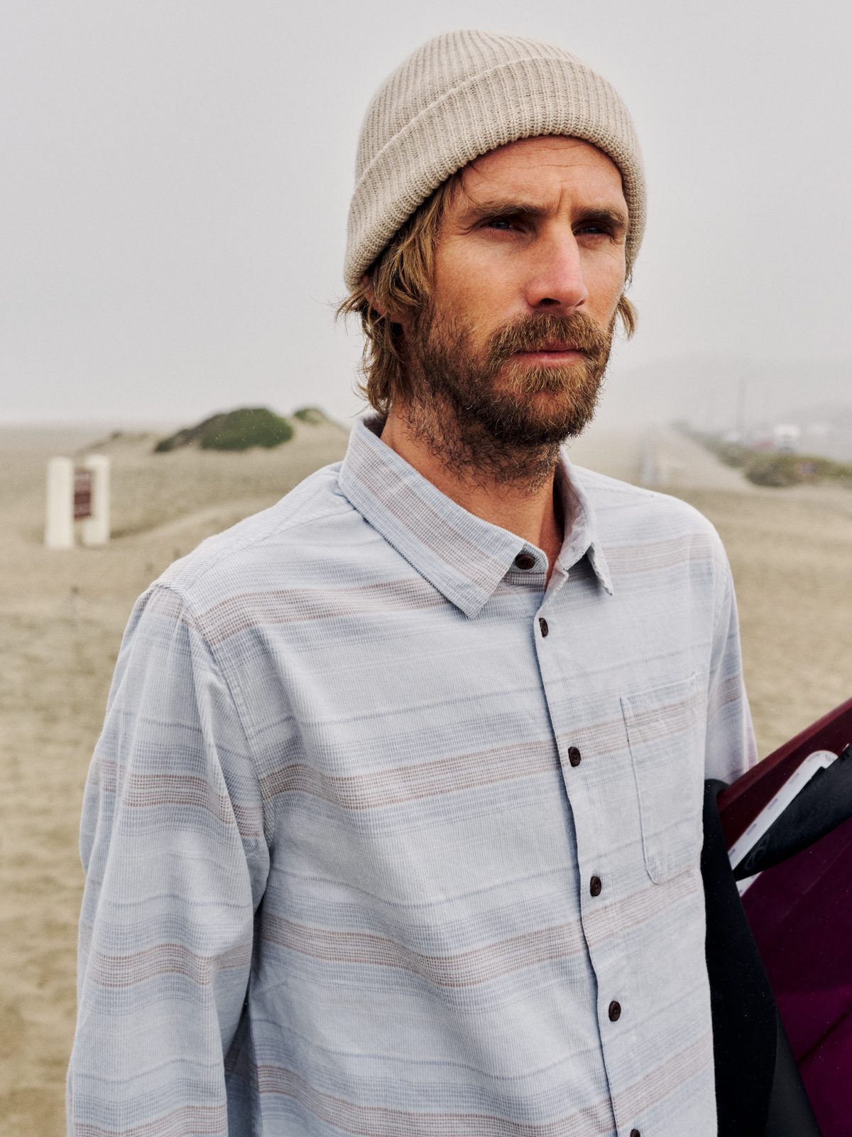 Katin Stevie Shirt in Light Blue, 18-wale corduroy with yarn-dyed stripe, on model on the beach, lifestyle #color_light blue
